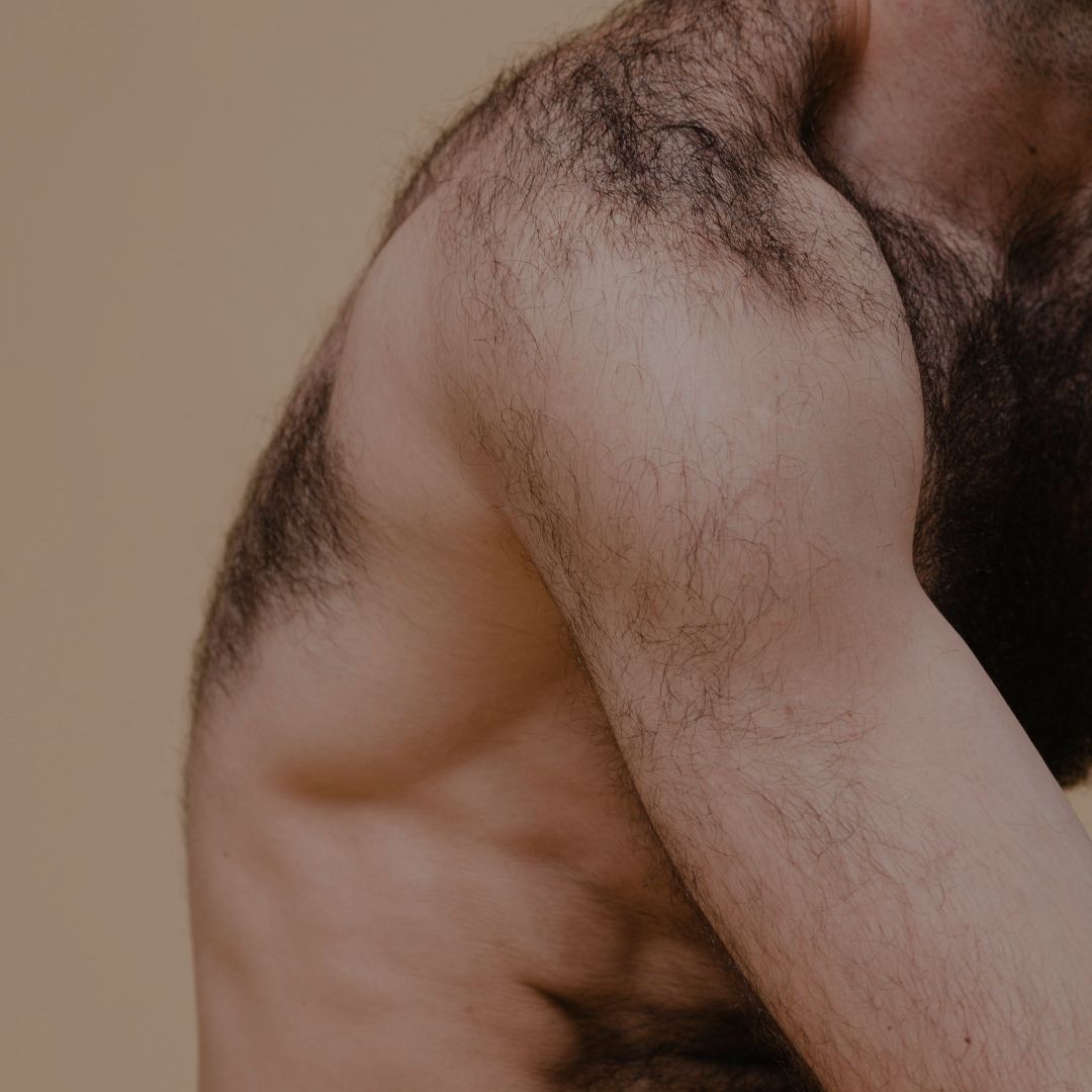 A man's back and arm with dark hair